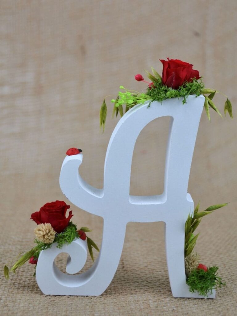 Letra A inicial de madera con flores preservadas