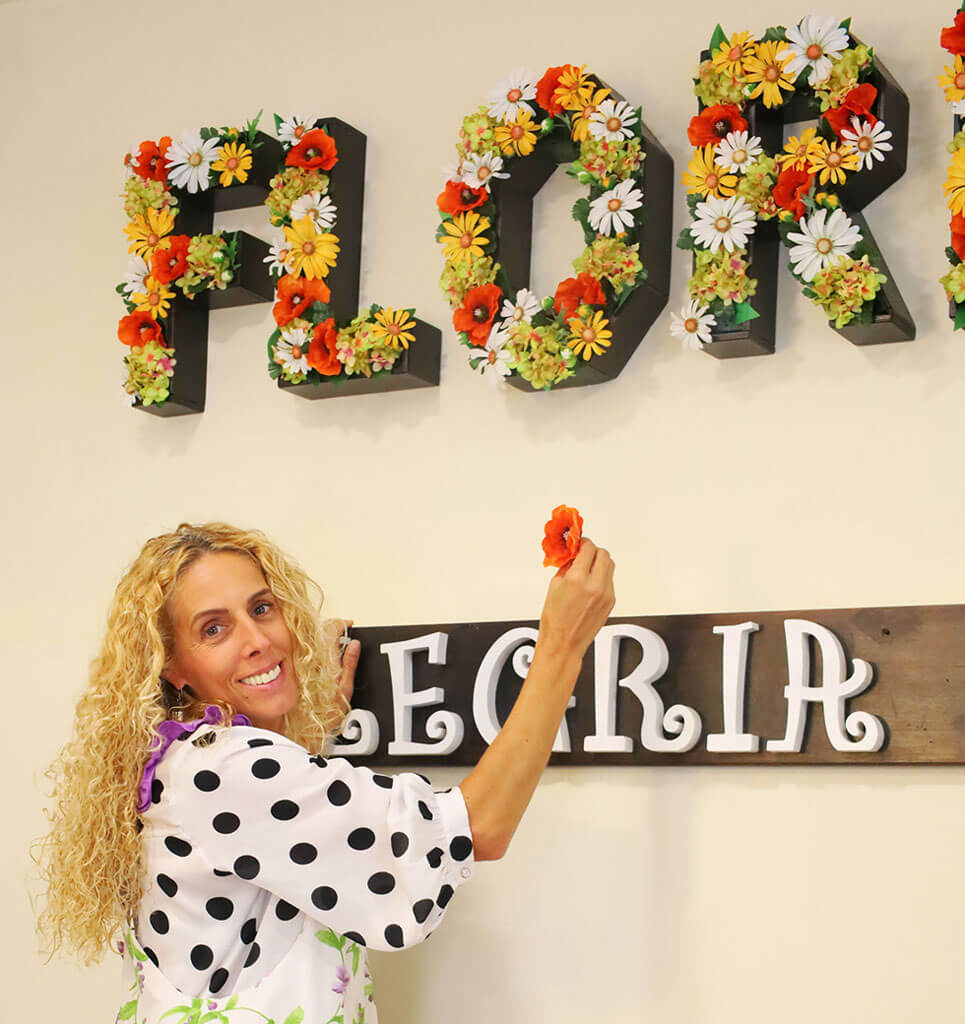 gloria floristeria florella decorando una pared con flores